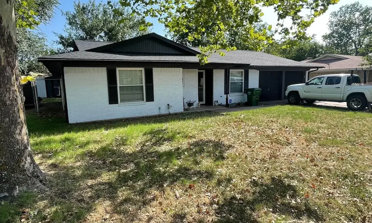 Professional roofing crew working on a residential roof in Country Club